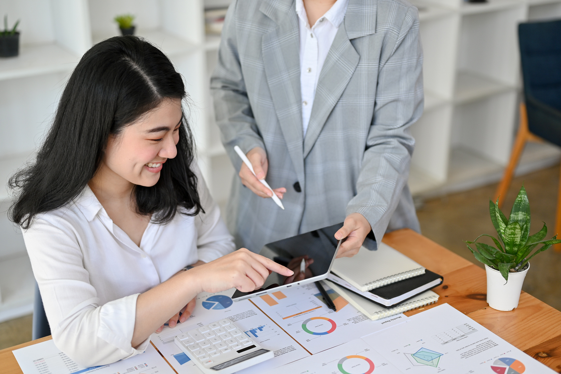 Professional Asian female financial manager explaining and coach